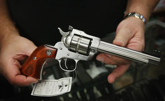 Fred Lutger, owner of Freddie Bear Sports, shows a Ruger Single Ten .22 caliber revolver.